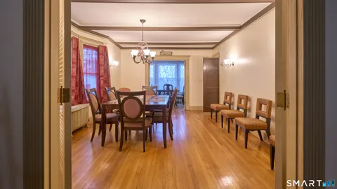 a view of a dining room with furniture and chandelier