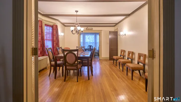 a view of a dining room with furniture and chandelier