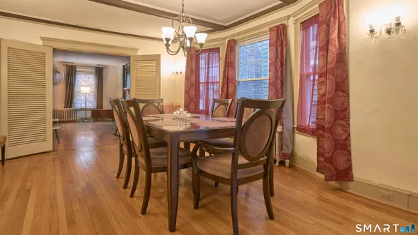 a view of a dining room with furniture window and wooden floor
