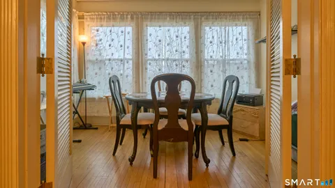 a view of a dining room with furniture window and wooden floor