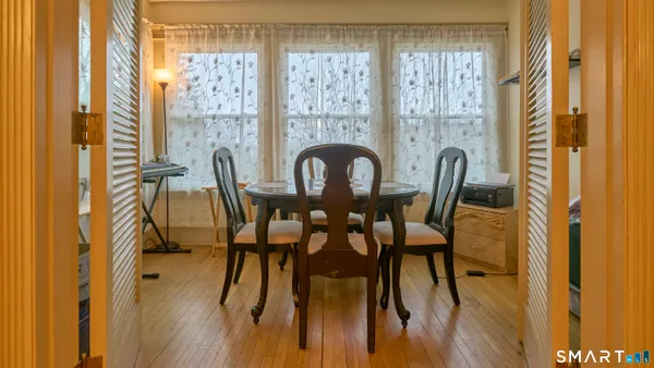 a view of a dining room with furniture window and wooden floor