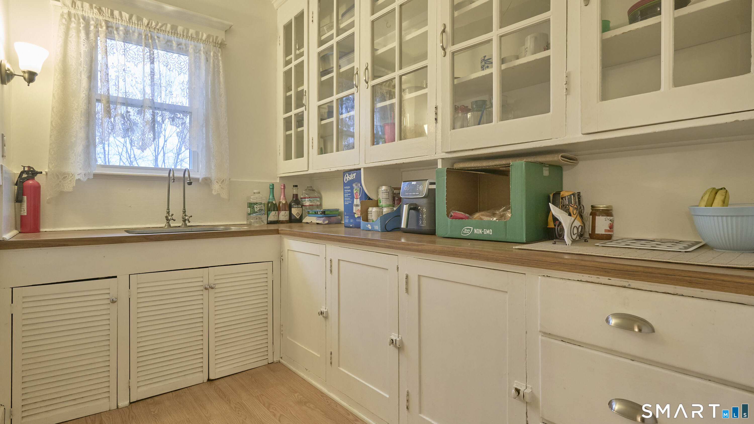 181 Buckingham Street Waterbury, CT 06710 - Photo 8 of 38 a kitchen with white cabinets and sink
