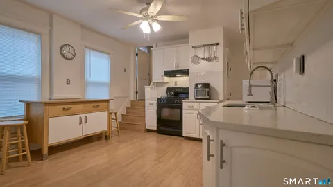 a kitchen with a sink cabinets and wooden floor