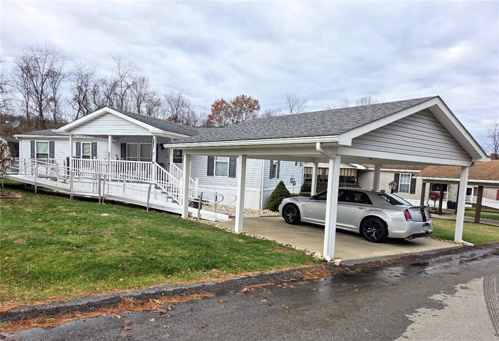 a car parked in front of a house with a yard