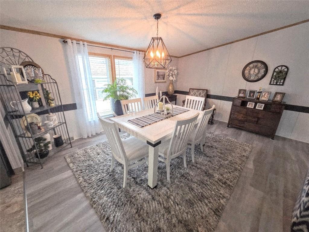 105 Eagle Pointe Estates New Eagle, PA 15067 - Photo 13 of 39 a dining room with furniture a chandelier and wooden floor