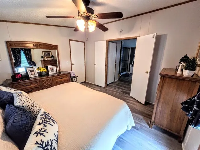 a bedroom with a bed and a mirror on the dresser