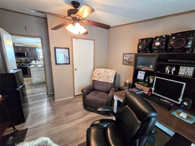 a living room with furniture a ceiling fan and a window