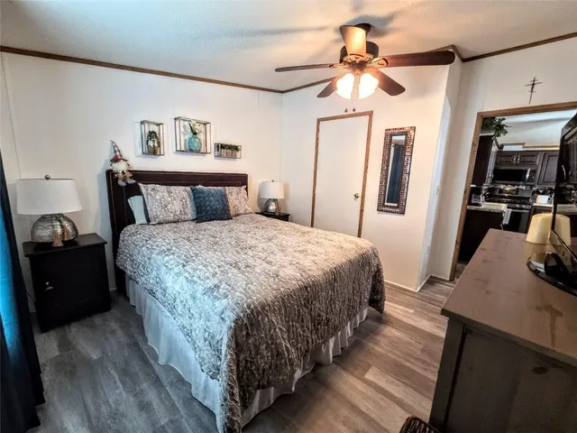 a bedroom with a bed and a chandelier