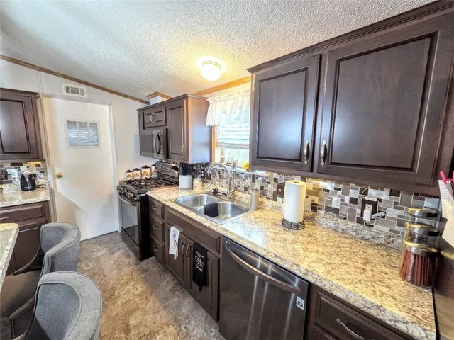 a bathroom with double vanity and a mirror