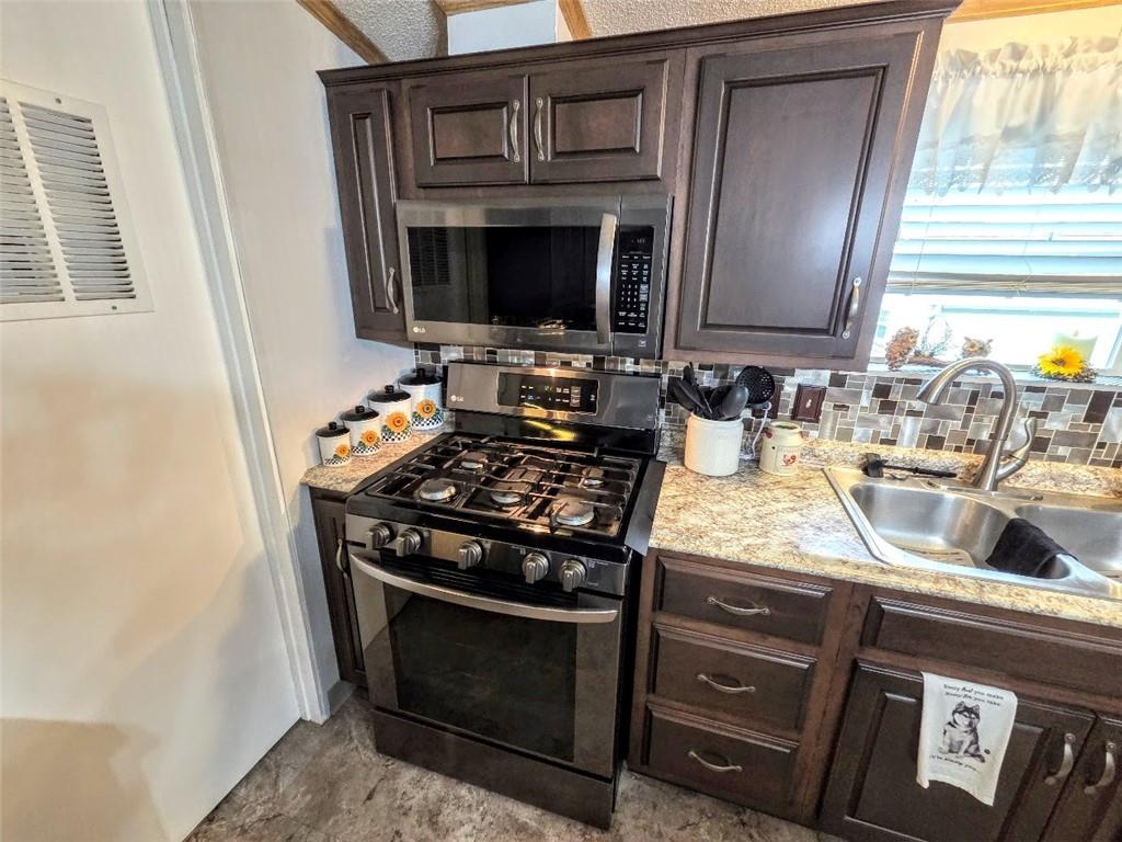 105 Eagle Pointe Estates New Eagle, PA 15067 - Photo 9 of 39 a kitchen with granite countertop stainless steel appliances a stove sink and microwave