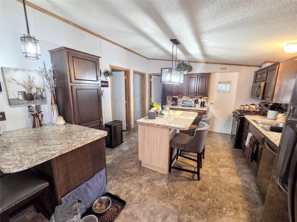 105 Eagle Pointe Estates New Eagle, PA 15067 - Photo 10 of 39 a kitchen with kitchen island a counter top space a sink stainless steel appliances and cabinets