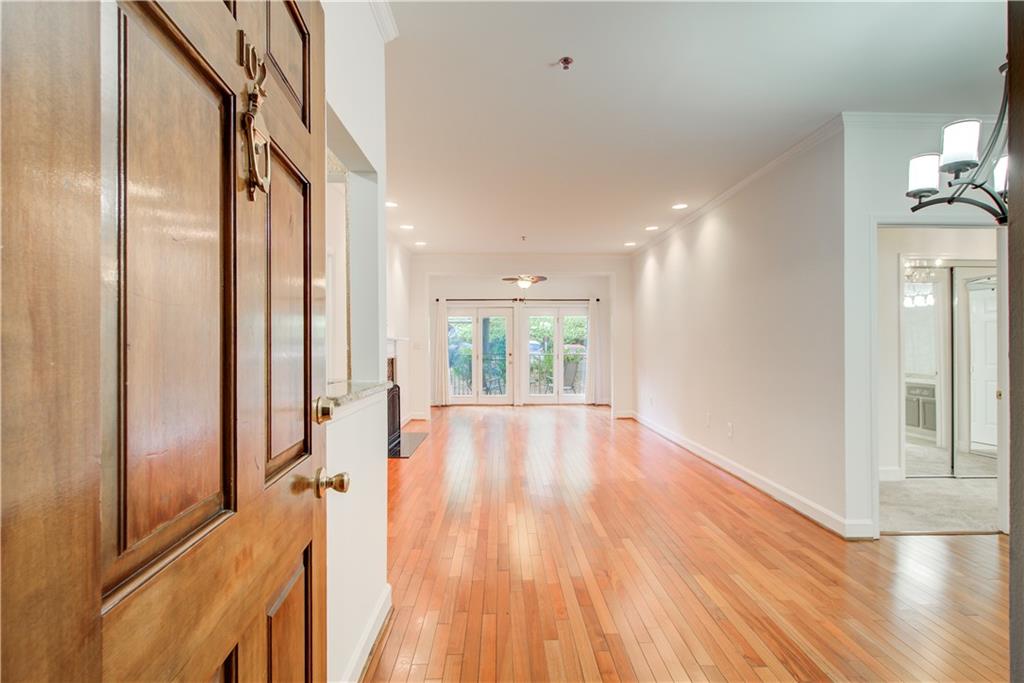 2865 Lenox Road Northeast, Unit 102 Atlanta, GA 30324 - Photo 3 of 35 a view of an entryway with wooden floor and livingroom view