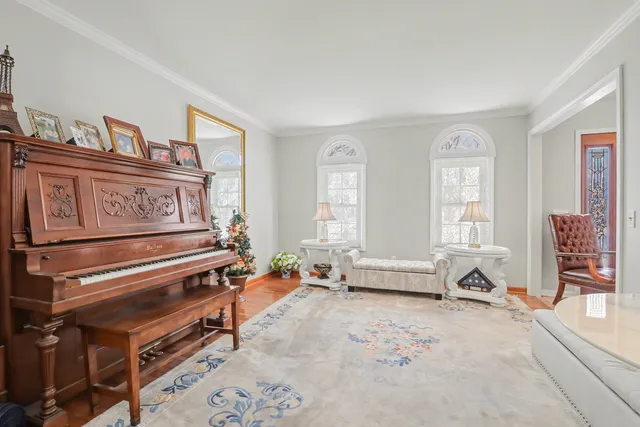a living room with furniture a fireplace and a large window