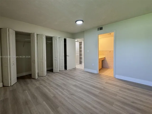 a view of a livingroom with wooden floor and a window