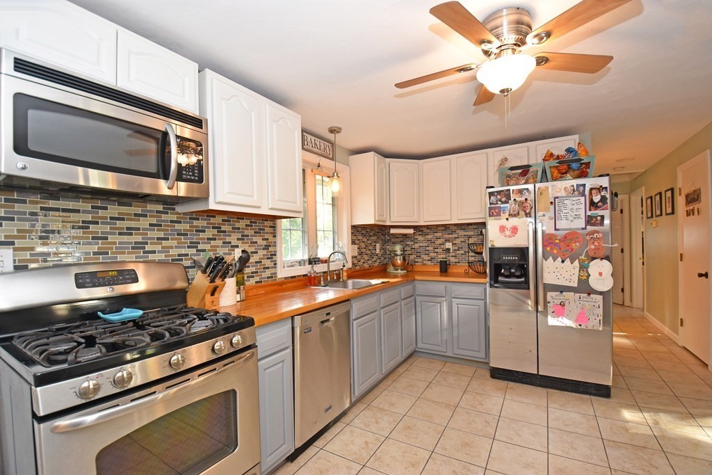 17 Ludlow Street Worcester, MA 01603 - Photo 4 of 23 a kitchen with stainless steel appliances a stove a sink and a microwave