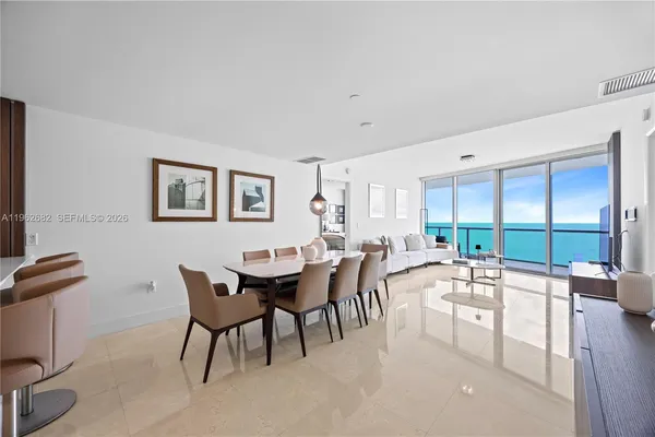 a room with lots of table chair and a large window
