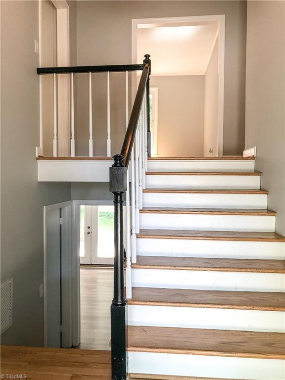 328 Hartgrove Road King, NC 27021 - Photo 11 of 25 Entry way from the front door showing stairs to upper level and lower level.