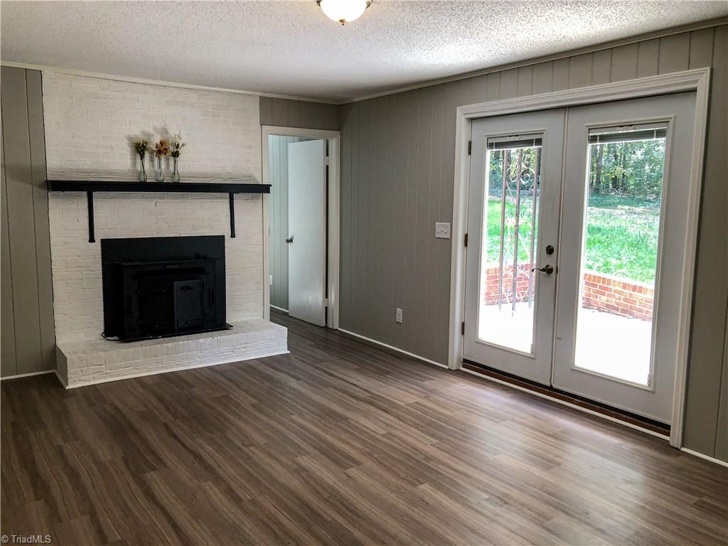 328 Hartgrove Road King, NC 27021 - Photo 18 of 25 Spacious Den on the lower level leads out onto a covered patio.