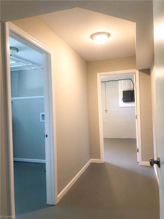 328 Hartgrove Road King, NC 27021 - Photo 21 of 25 Hallway on the lower level. The large laundry room is to the left and a 1/2 bath is at the end of the hallway.