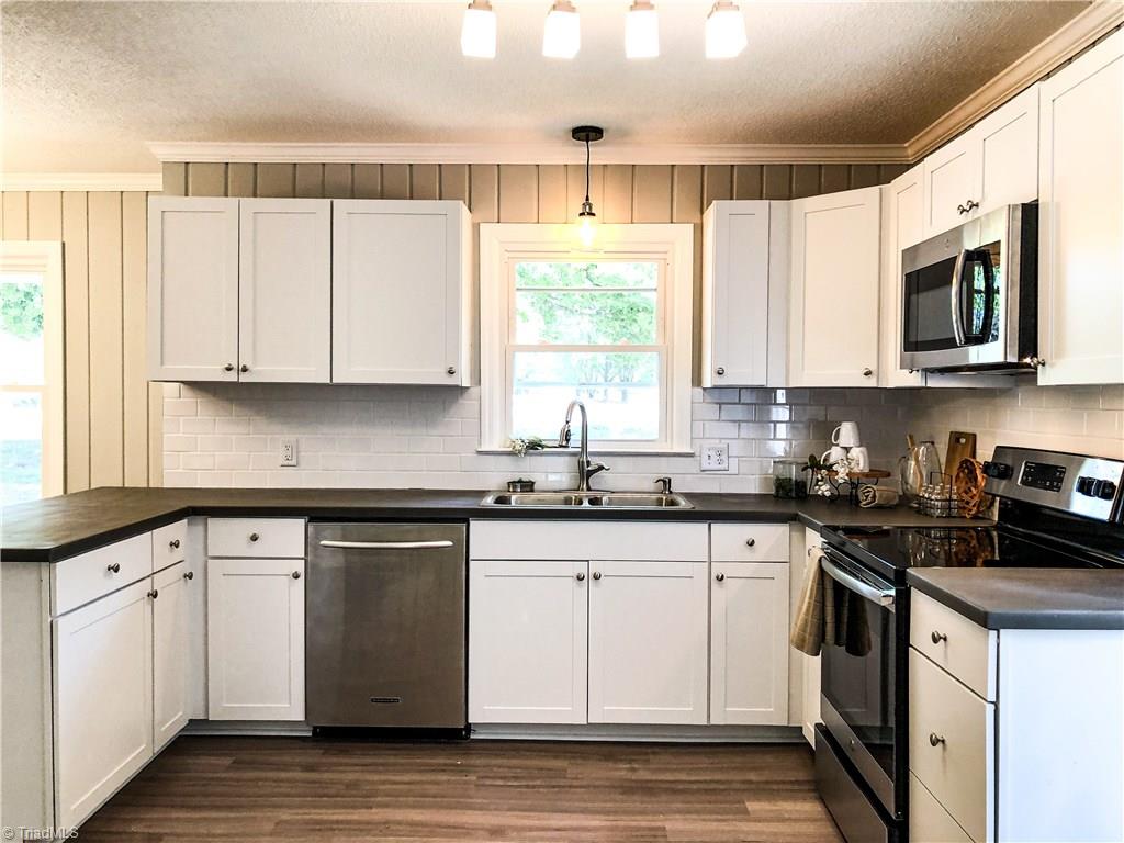 328 Hartgrove Road King, NC 27021 - Photo 5 of 25 This Beautiful White and Bright Kitchen has all new cabinets, counter tops, stainless steel appliances, subway tile and solid surface counter tops.