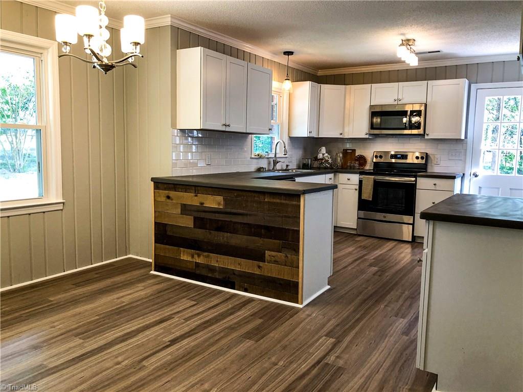 328 Hartgrove Road King, NC 27021 - Photo 6 of 25 Eat in Breakfast Bar and built in cabinets give plenty of room for all your kitchen supplies.