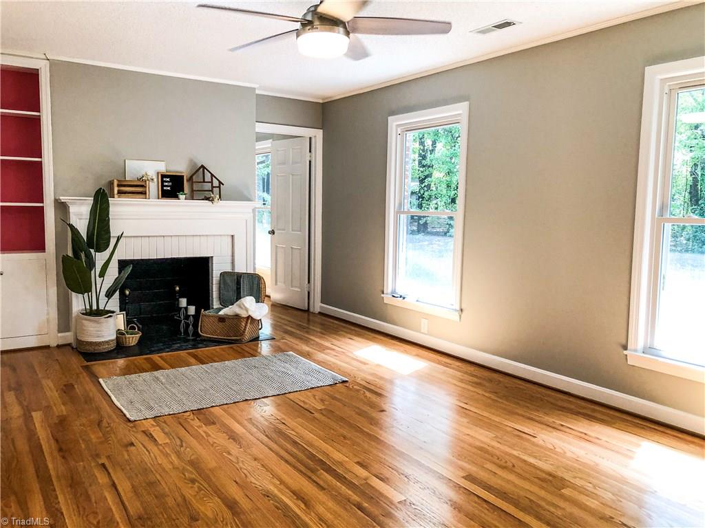328 Hartgrove Road King, NC 27021 - Photo 8 of 25 This spacious Living room on the upper level has original hardwoods, built in book case, fireplace and large windows overlooking the back yard.