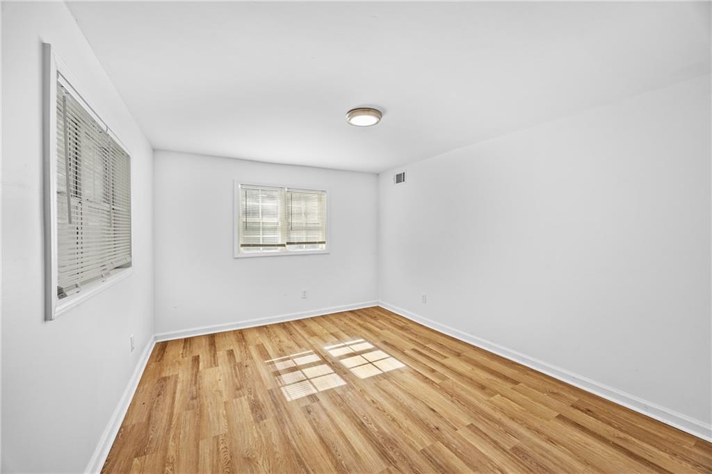 1339 Lyle Avenue Atlanta, GA 30344 - Photo 11 of 21 a view of an empty room with wooden floor and a window