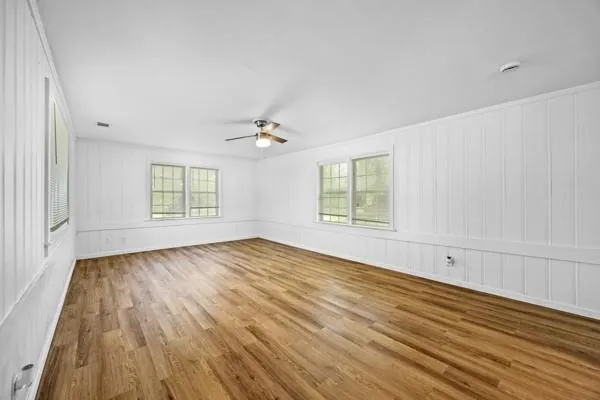 wooden floor in an empty room with a window