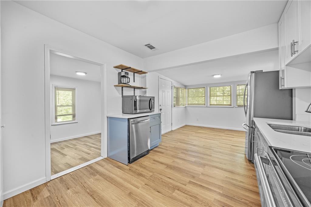 1339 Lyle Avenue Atlanta, GA 30344 - Photo 7 of 21 a view of kitchen and empty room with wooden floor