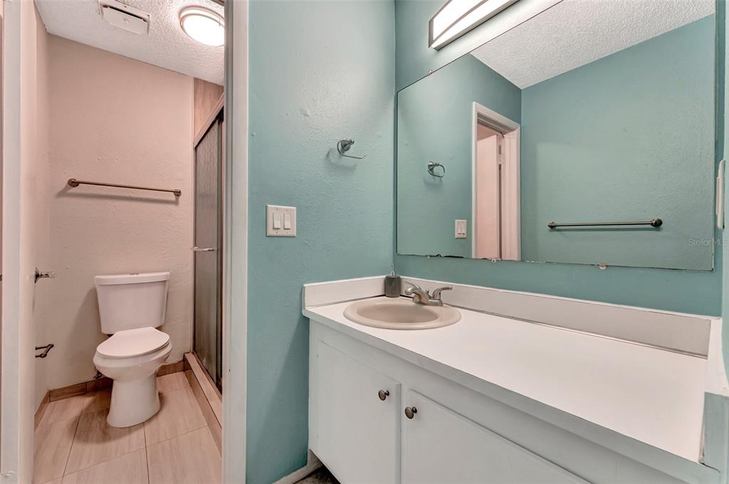 13300 Walsingham Road, Unit 56 Largo, FL 33774 - Photo 30 of 35 a bathroom with a sink a toilet and a mirror