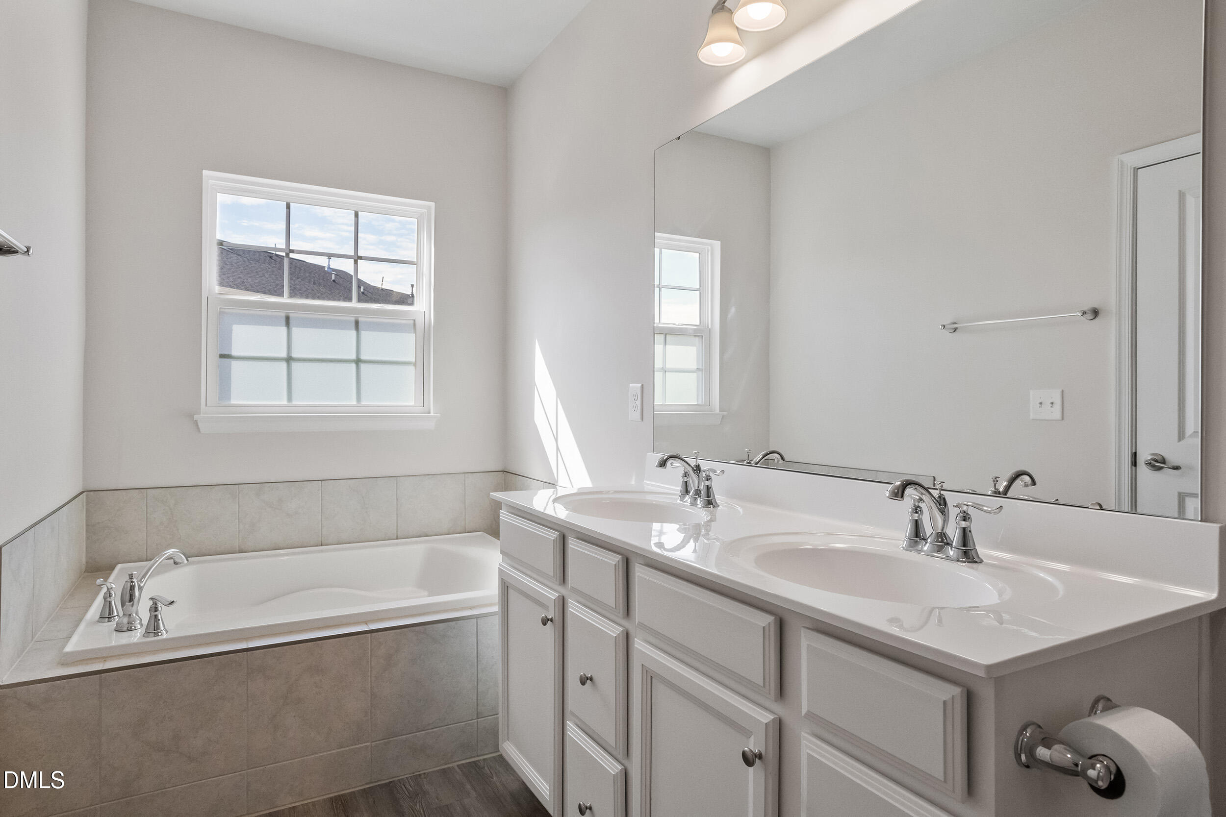 1124 Platform Drive Apex, NC 27502 - Photo 24 of 34 a bathroom with a tub sink and mirror