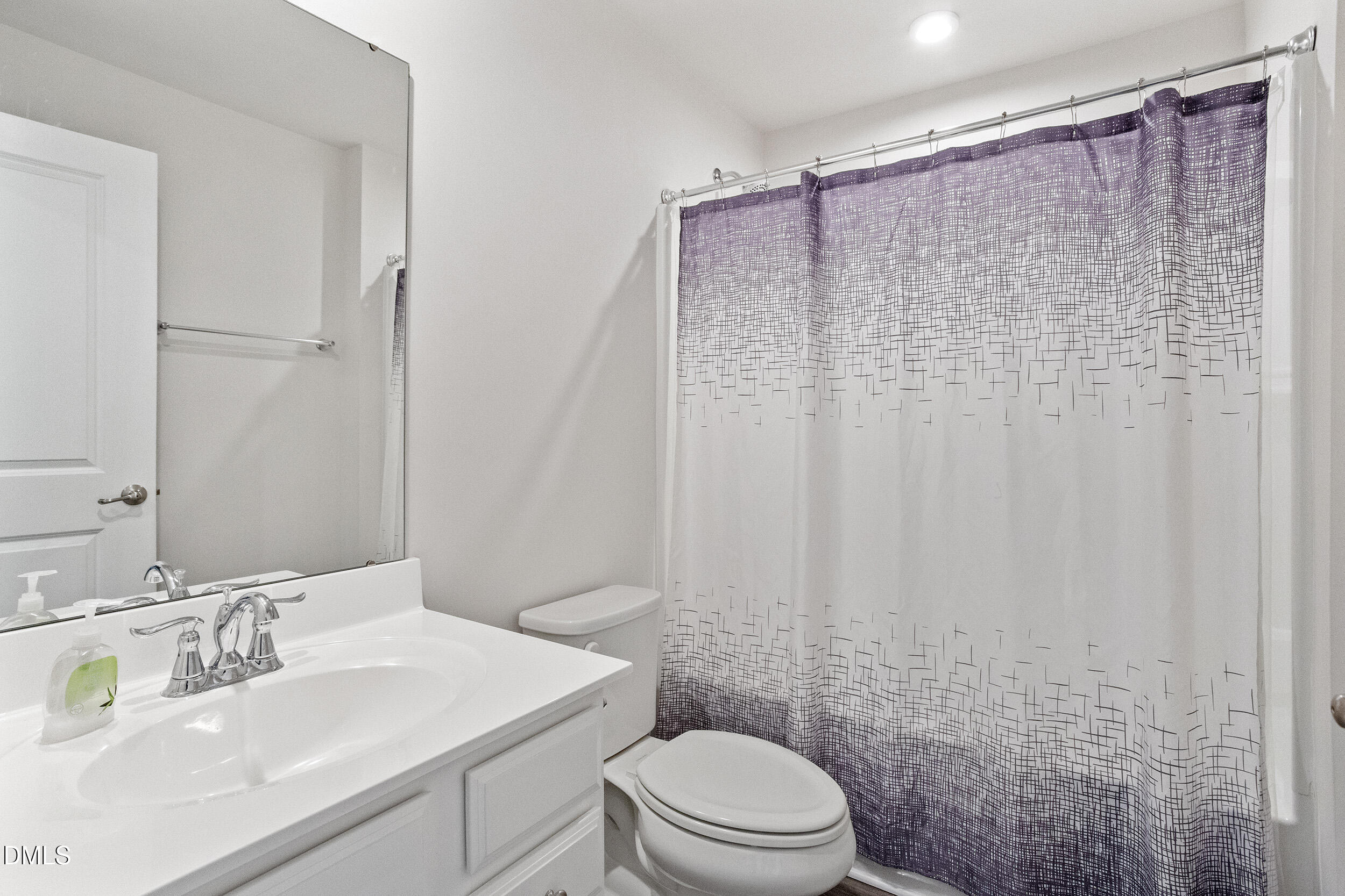 1124 Platform Drive Apex, NC 27502 - Photo 6 of 34 a bathroom with a sink a toilet and shower curtain