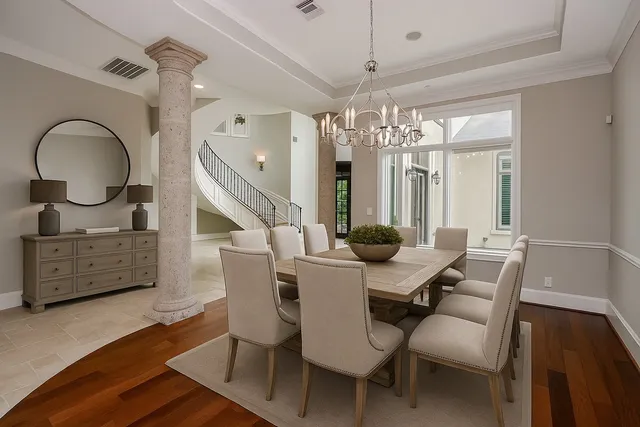 a view of a dining room with furniture and chandelier