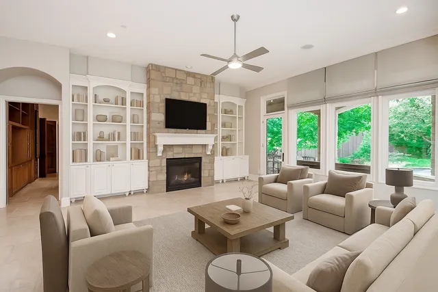 a living room with furniture a fireplace and a flat screen tv