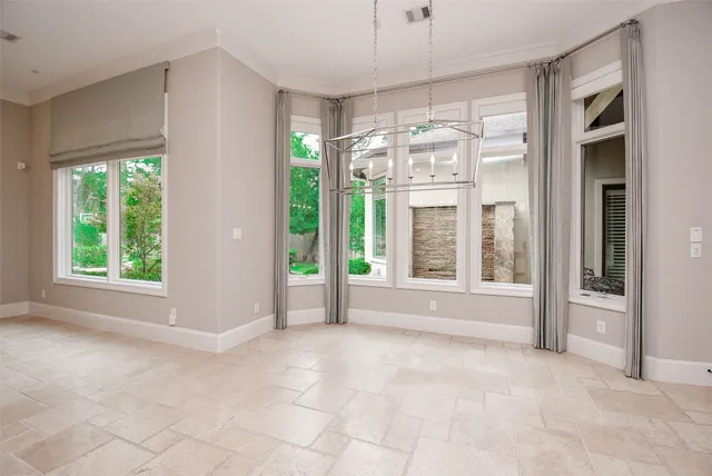 a view of an empty room with a fireplace and a large window with outer view