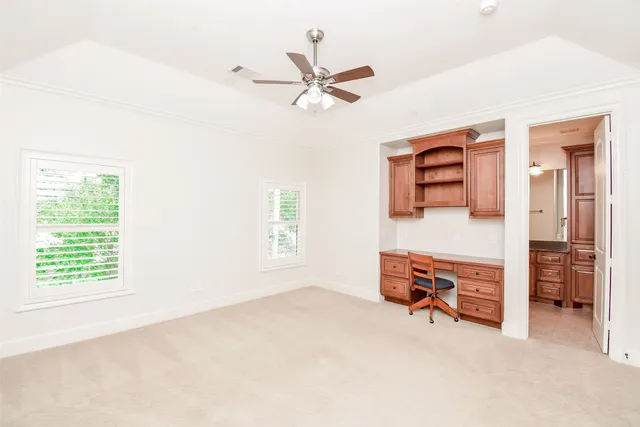 a view of room with window and a ceiling fan