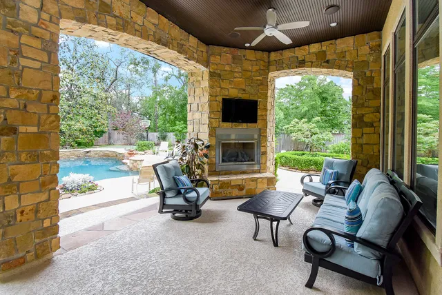 a living room with patio furniture and a fireplace