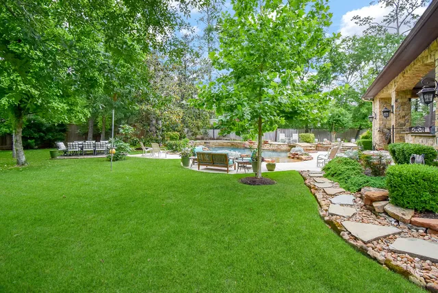 a front view of a house with a yard table and chairs