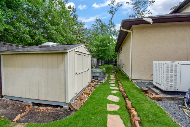 a view of a backyard with wooden fence