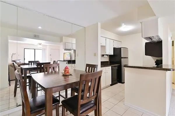 a dining room with stainless steel appliances furniture a dining table and chairs