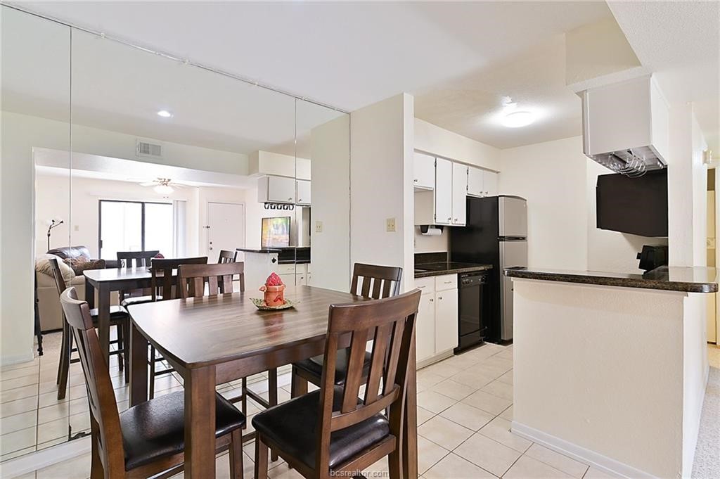 904 University Oaks Boulevard, Unit 155 College Station, TX 77840 - Photo 4 of 11 a dining room with stainless steel appliances furniture a dining table and chairs