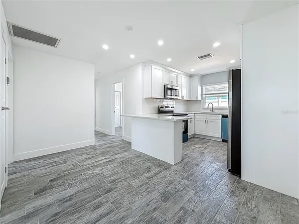 a view of kitchen with wooden floor