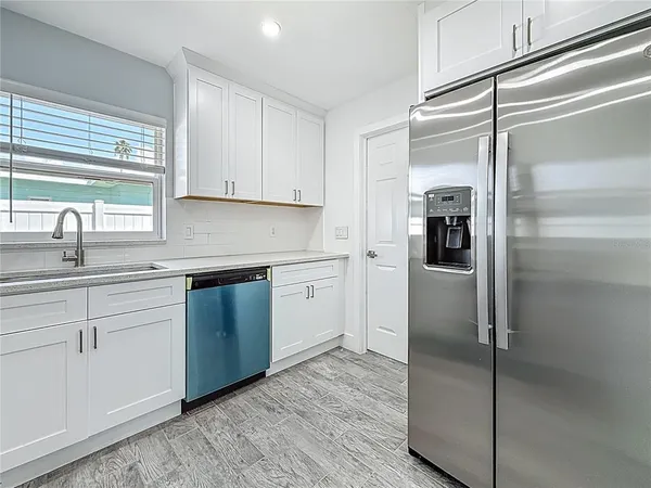 a kitchen with a refrigerator and a sink