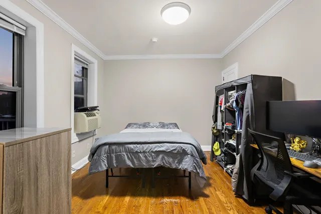 a bedroom with a bed and a desk