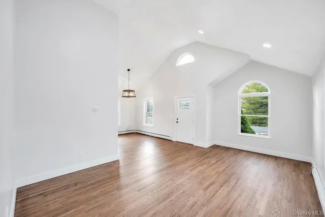 a kitchen with a refrigerator a sink and wooden floor