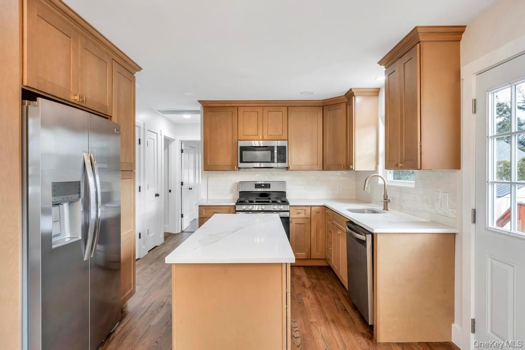 160 Oak Street Mattituck, NY 11952 - Photo 6 of 29 a kitchen with stainless steel appliances a refrigerator stove and sink
