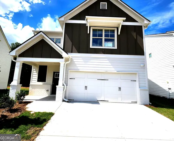 a front view of a house with garage