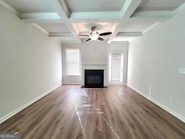 wooden floor in an empty room with a fireplace