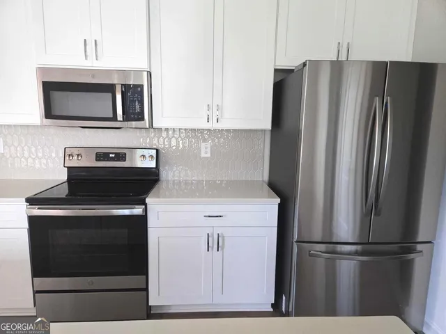 a kitchen with a stove microwave and refrigerator