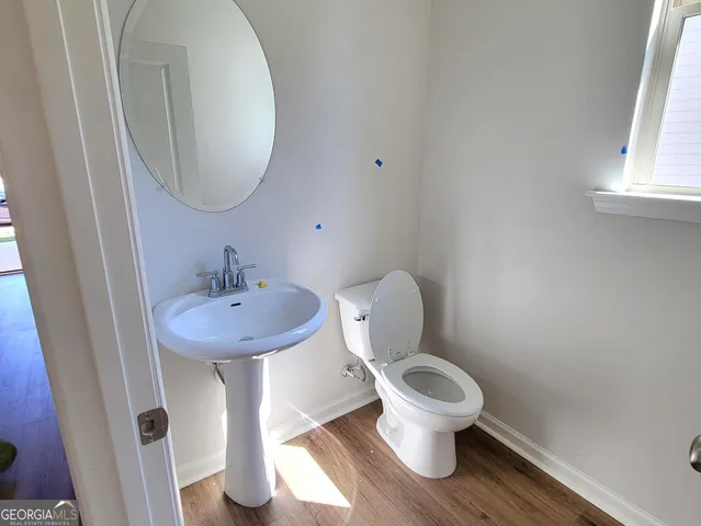 a bathroom with a toilet a sink and a mirror